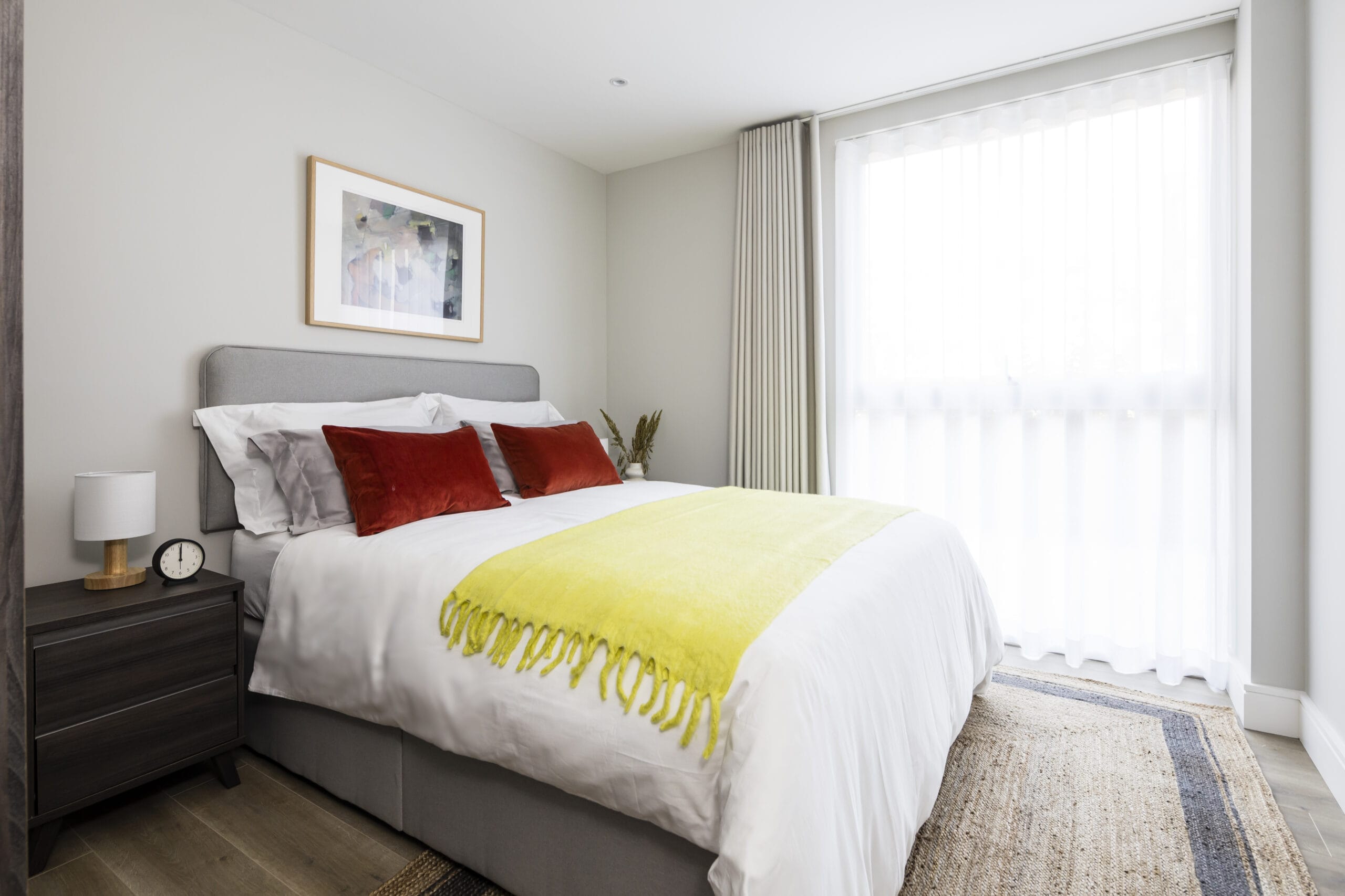 A bright and airy bedroom with a king size bed and 2 bedside tables.