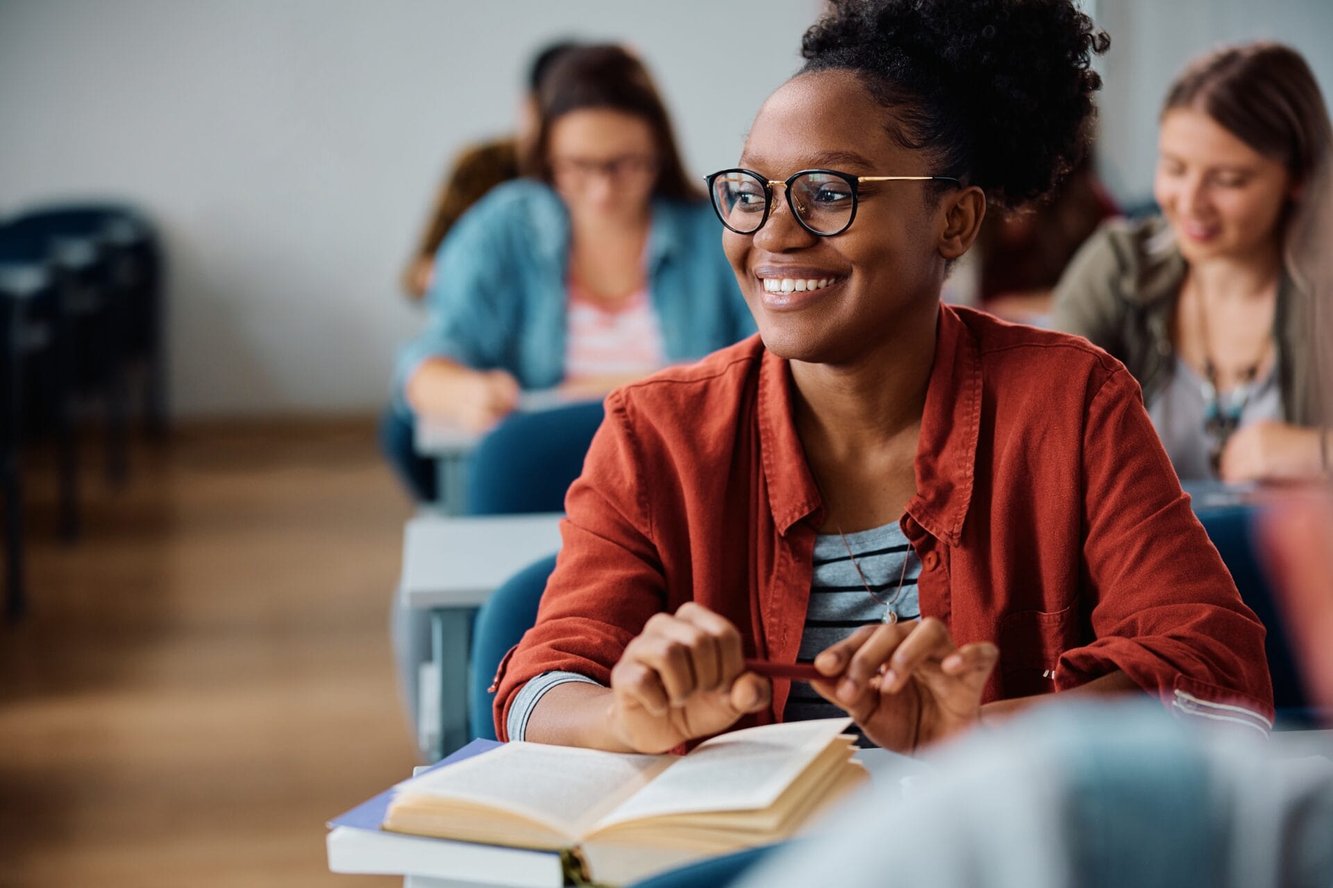 A young adult attending a university lecture.