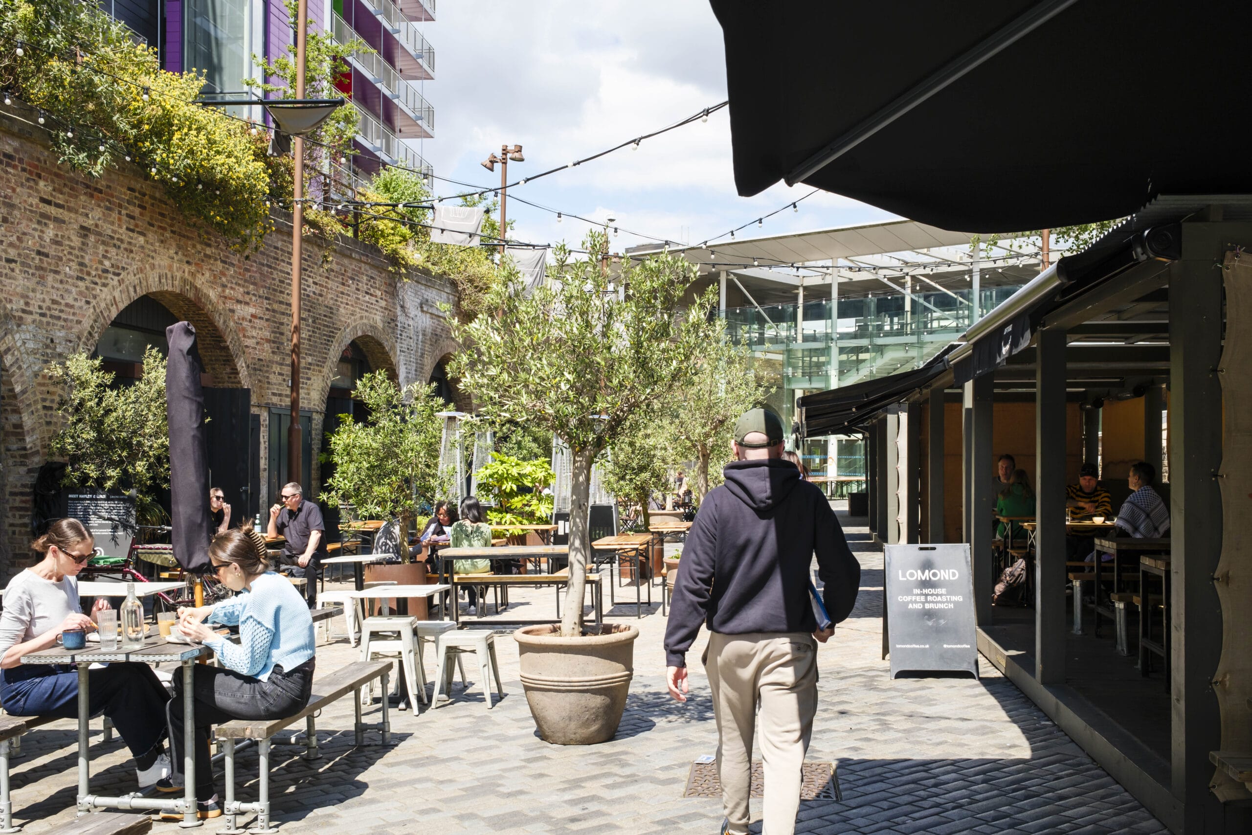 People enjoying the various food & drink available at Deptford Market Yard.