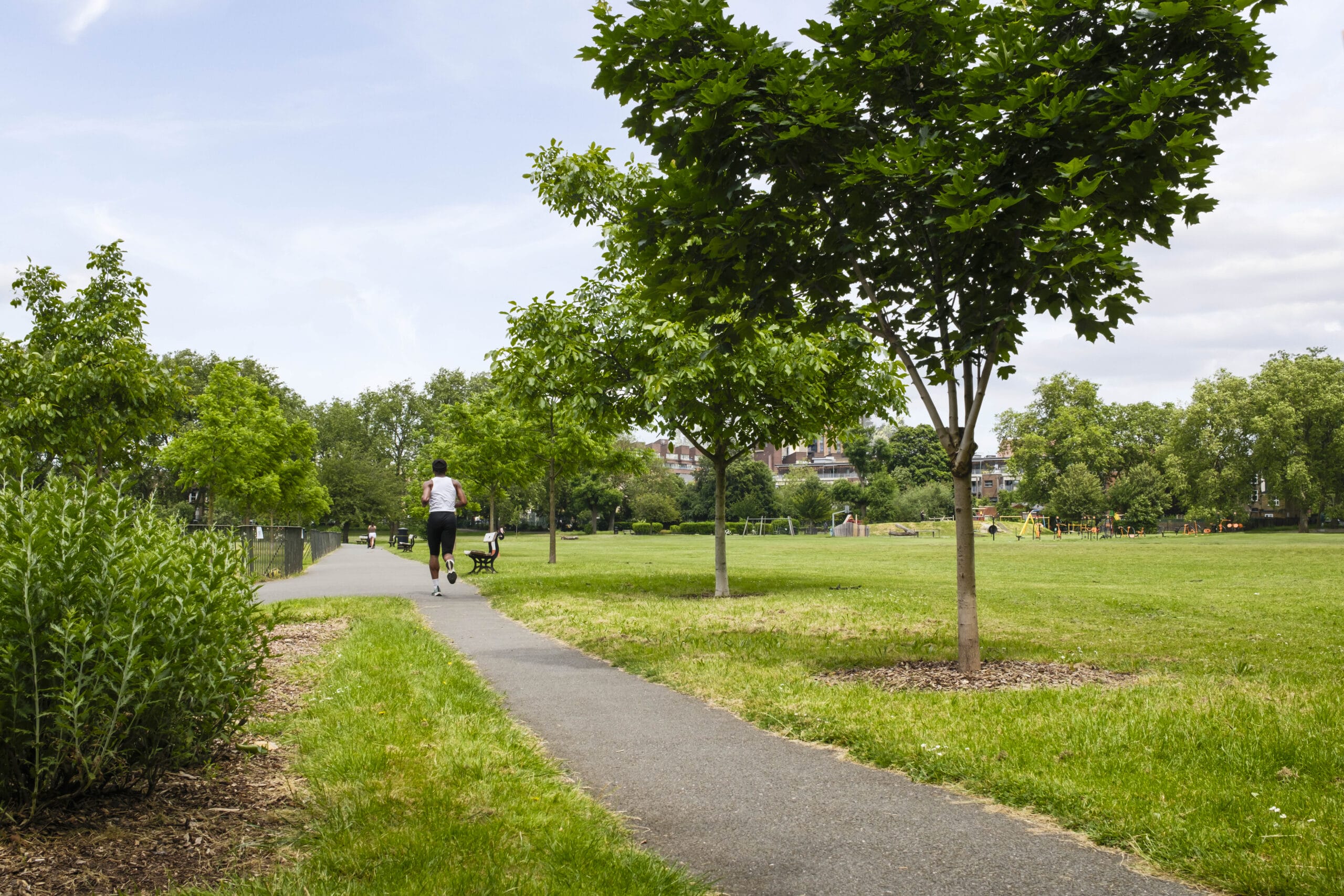 A man running through Deptford Park highlighting the beauty of the nature around him.