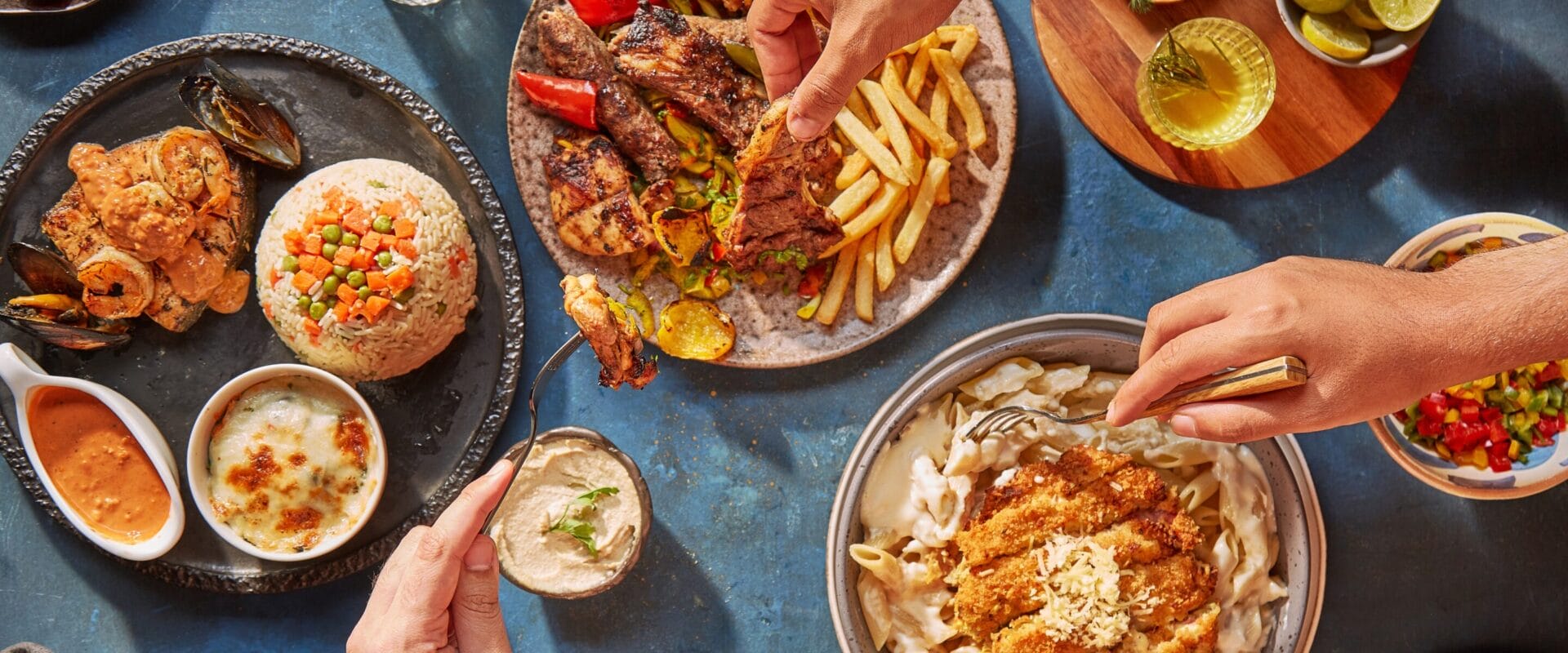 A top-down shot of people digging into their meals.