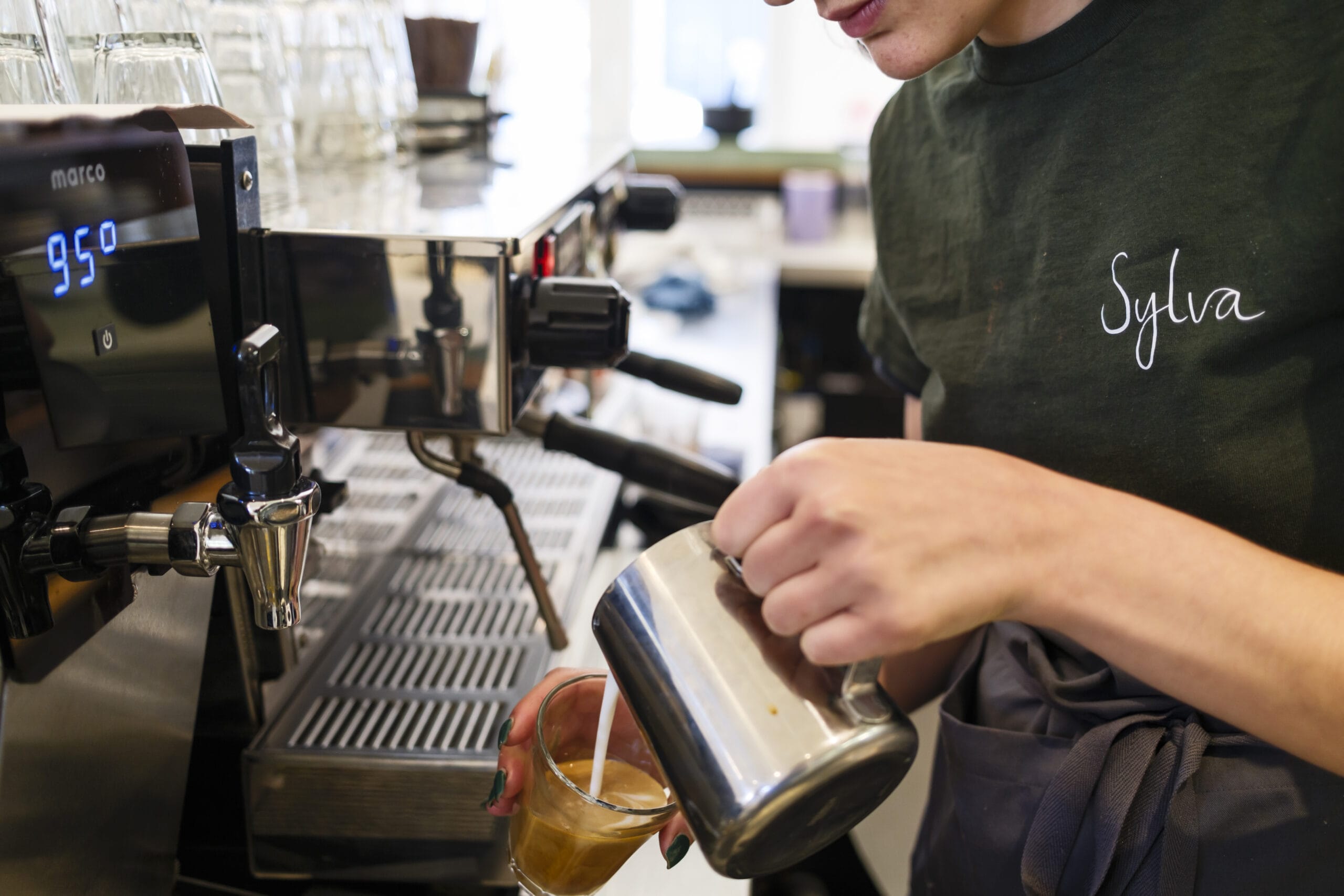 A barista at Sylva Cafe in Deptford making a coffee.