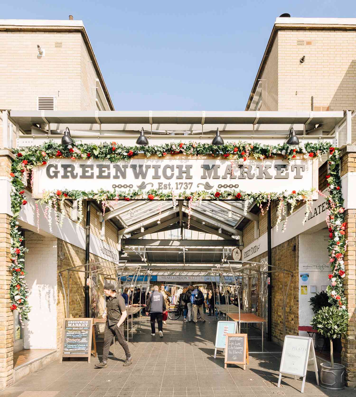 The entrance to Greenwich Market covered in flowers.