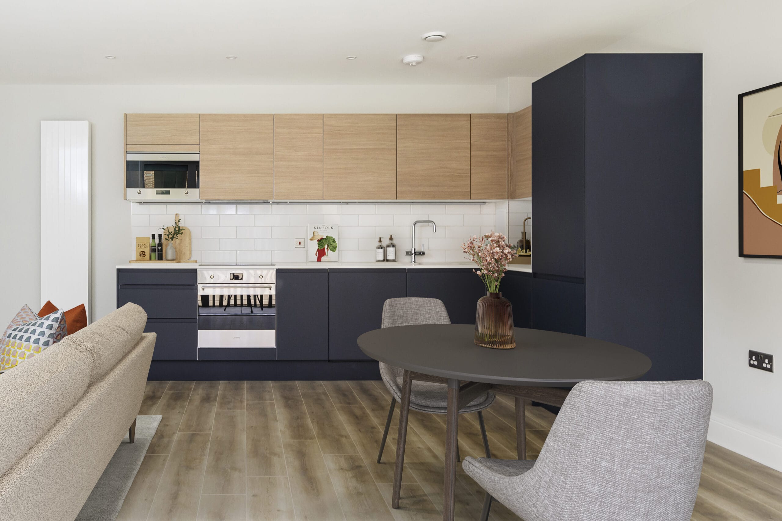 A modern kitchen with integrated appliances. The lower cupboards are a dark blue and the upper cupboards are a light wood.