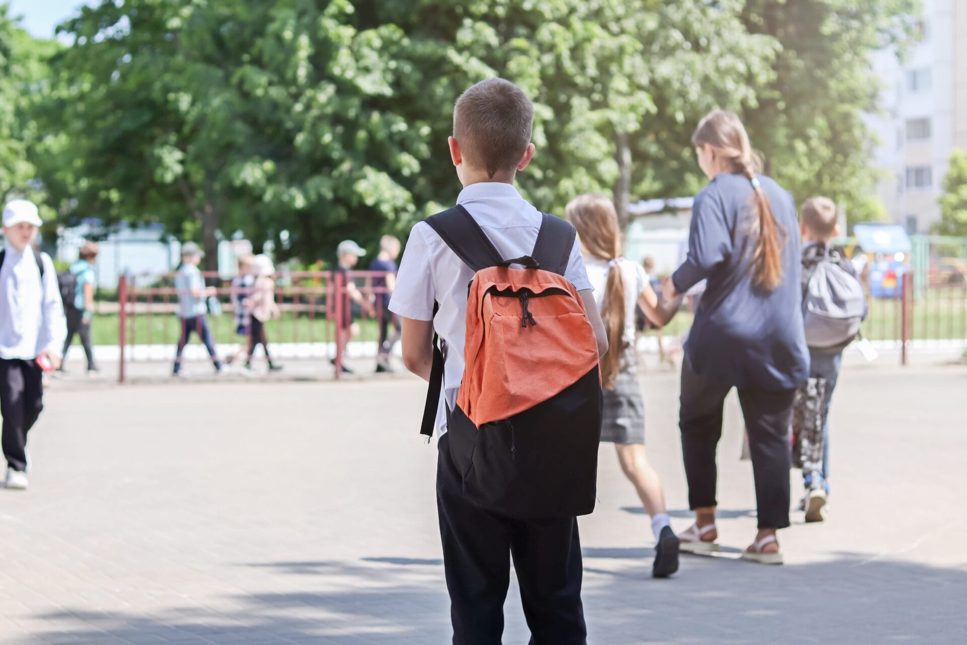 A child in the playground of a school.