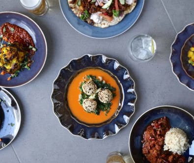 A top-down view of a dinning table with a selection of Indian cuisine.