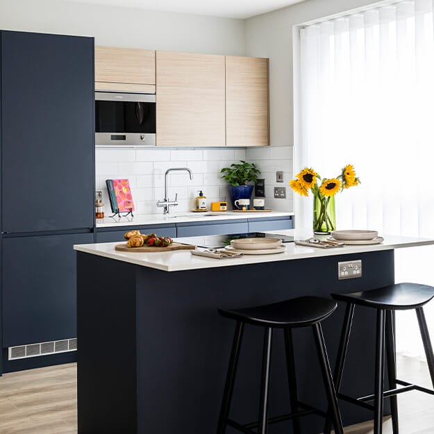 A kitchen with an island at Neptune Wharf in Deptford