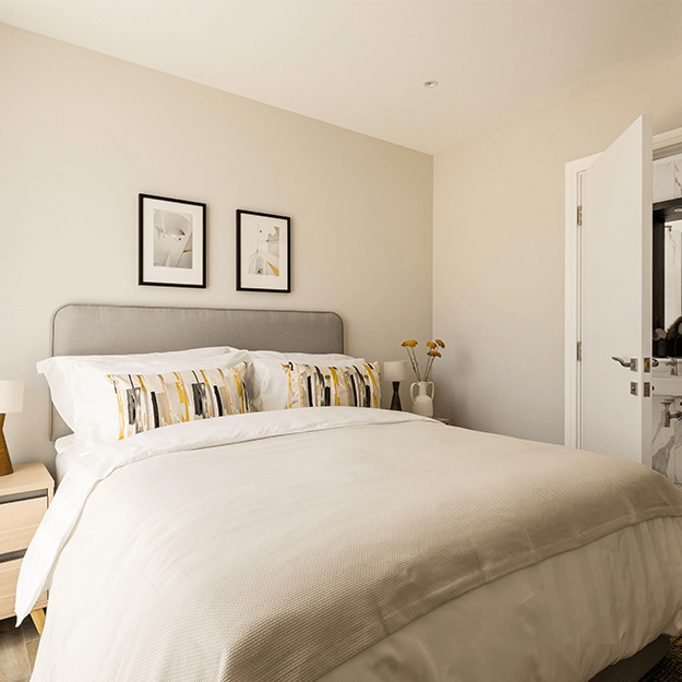 A bright and airy bedroom with a spacious built in wardrobe, a king size bed, 2 bedside tables and a sliding door to access the private outdoor terrace.