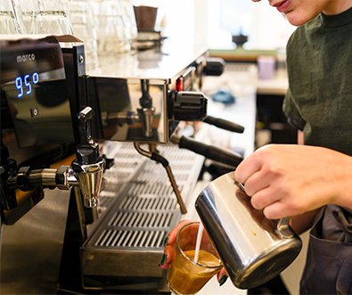 A barista at Sylva Cafe in Deptford making a coffee.